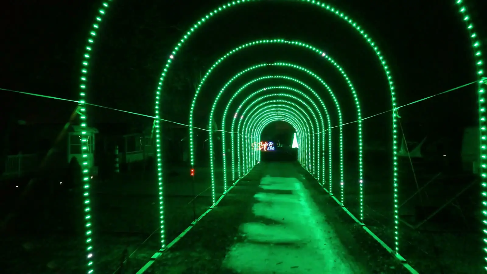 Drone fly-through of a lit holiday light tunnel