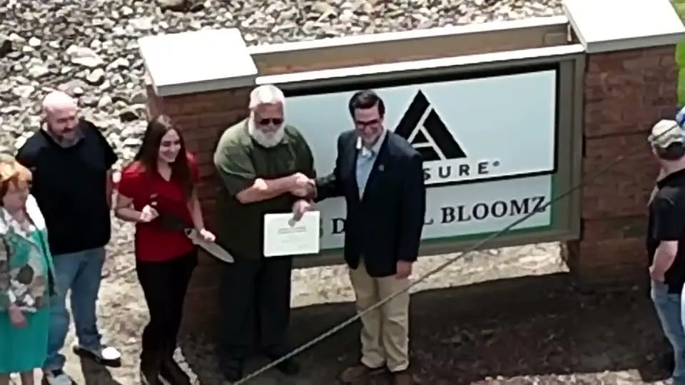 Drone Photography & Aerial Imaging 9 Drone photo of the ribbon cutting handshake at the Digital Bloomz office sign